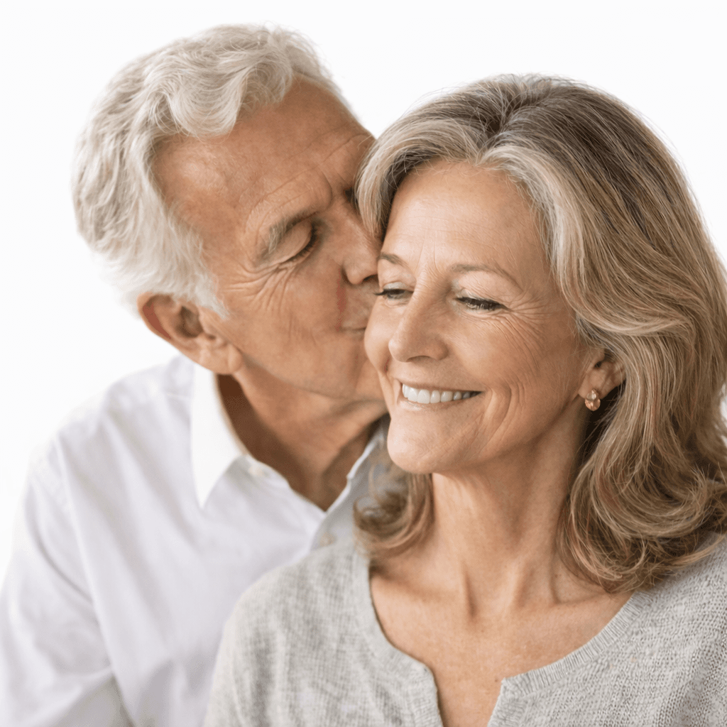 An older couple walking together near the water in Naples