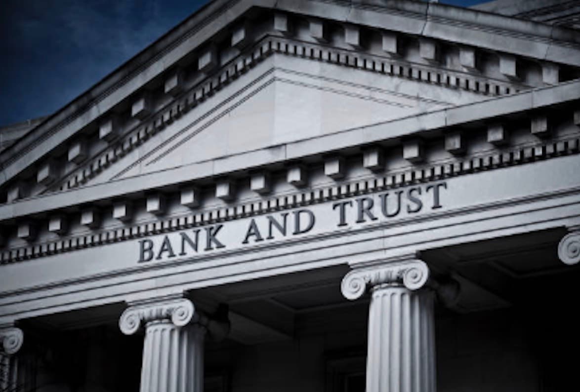 The classical stone columns and façade of a bank and trust building