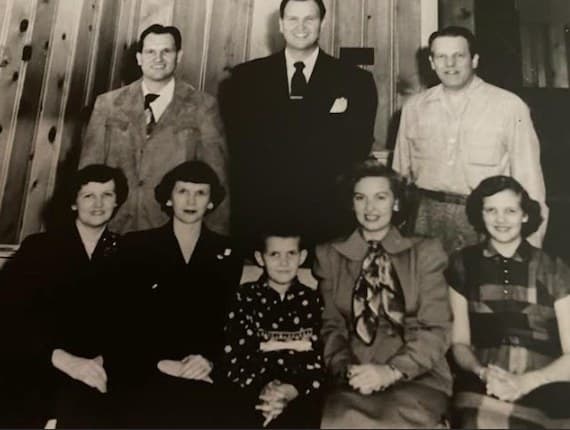 Vintage black-and-white portrait of the Cox family, with Joe as a boy seated in front