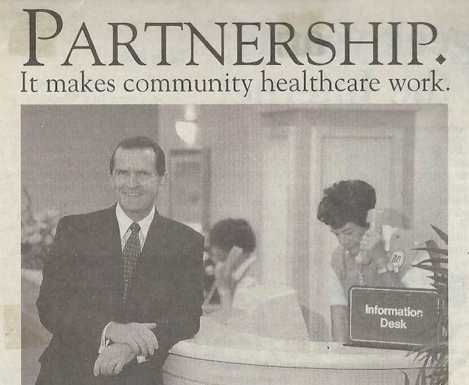 Joseph Cox at a Naples Community Hospital information desk in a community-healthcare feature